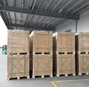 Stacks of wooden crates and pallets in a warehouse for shipping and storage.